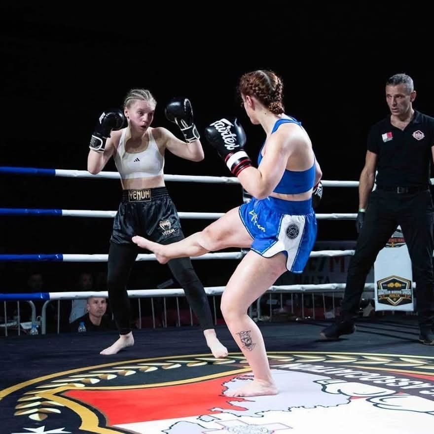 Two kickboxers exchanging in the ring mid-bout